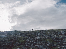 man hiking on a mountaintop 