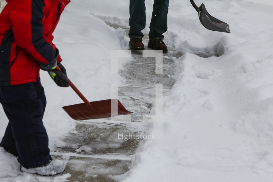 a father and son shoveling snow