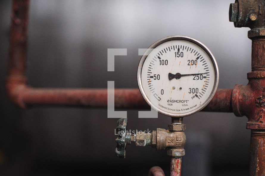 Old pipes with a temperature gauge.