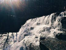 A sunlit waterfall.