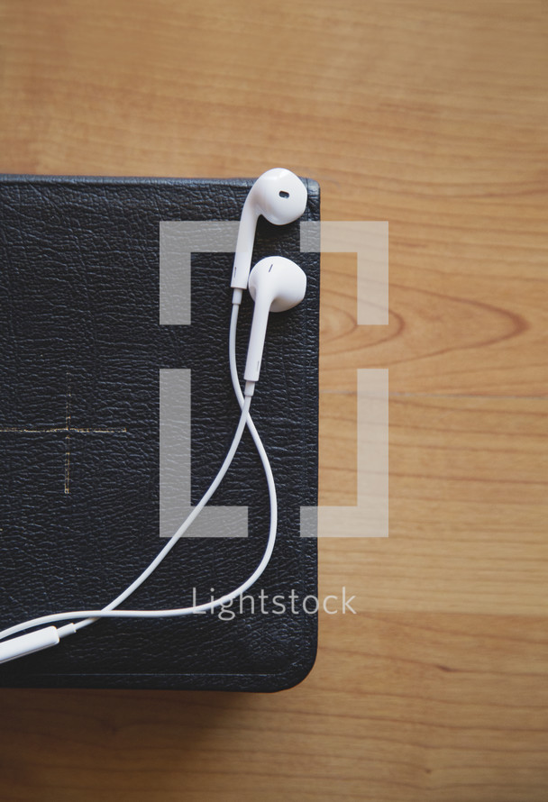 Concept for spiritual podcast, Bible and earbuds 
