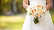 Wedding bouquet of roses in the hands of the bride