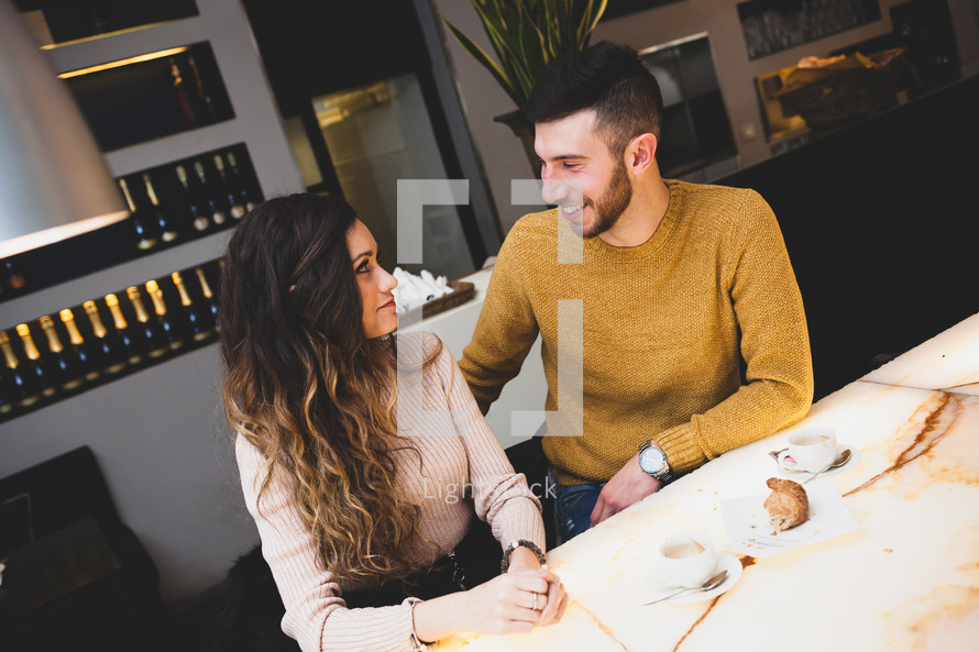 young couple having breakfast at a restaurant together 