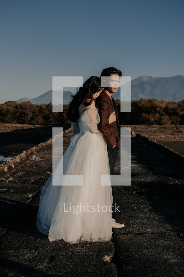 portrait of a bride and groom on a beach 