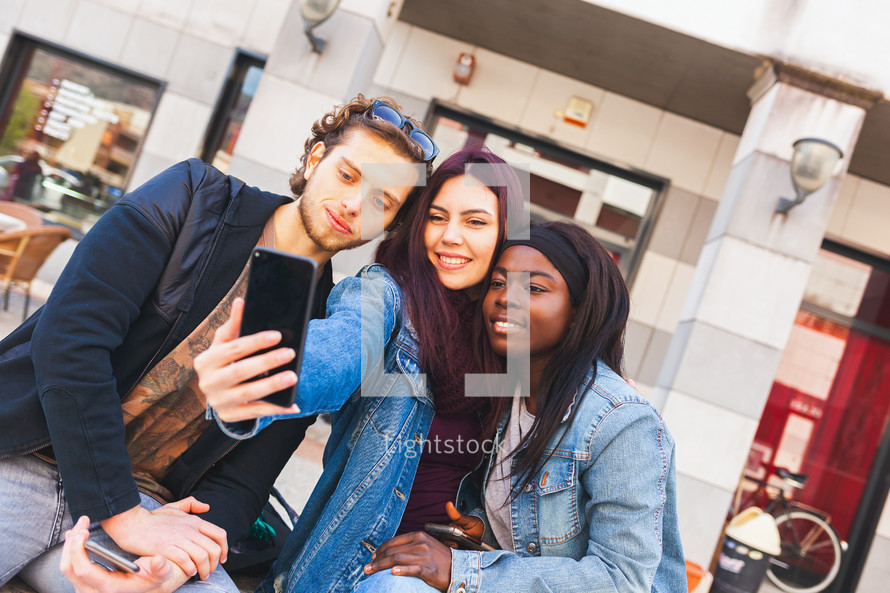 Three friends take a selfie. multicultural friendship concept.