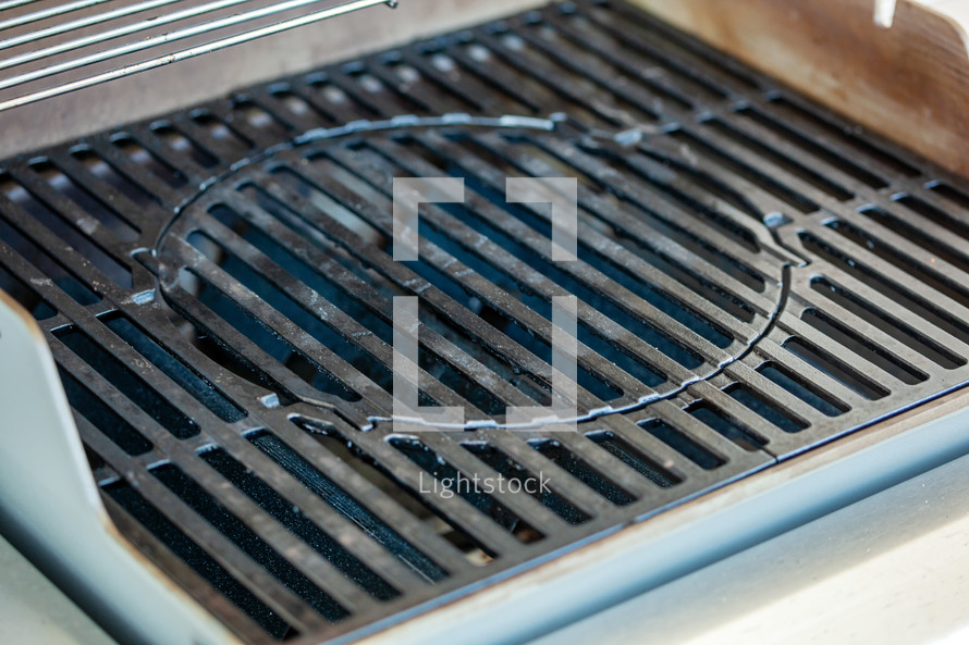 Cast iron barbecue grill to clean.