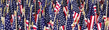 closeup of many US flags in wide / banner format