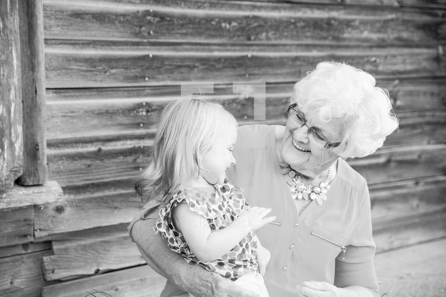 great-grandmother and great-granddaughter hugging 