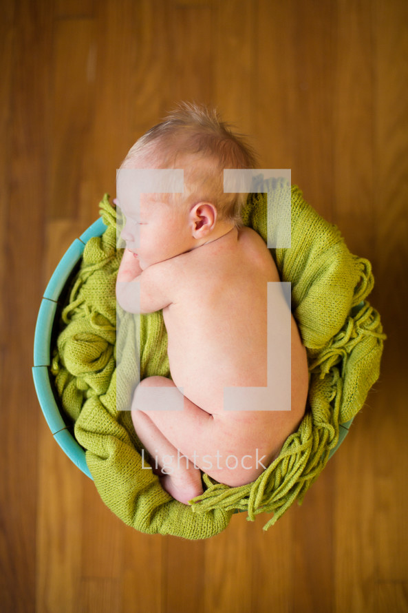 naked newborn in a basket