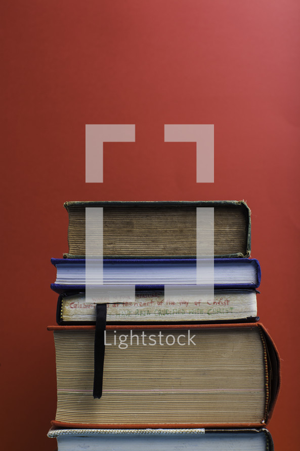 stack of book against a red background 