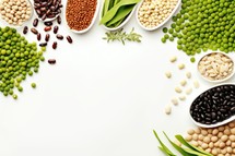 Assortment of legumes in bowls on white background, top view