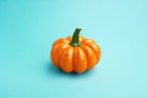 Pumpkin on blue background with copy space. Minimal style