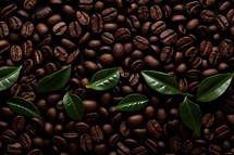 Coffee beans with green leaves on a dark background. Top view.