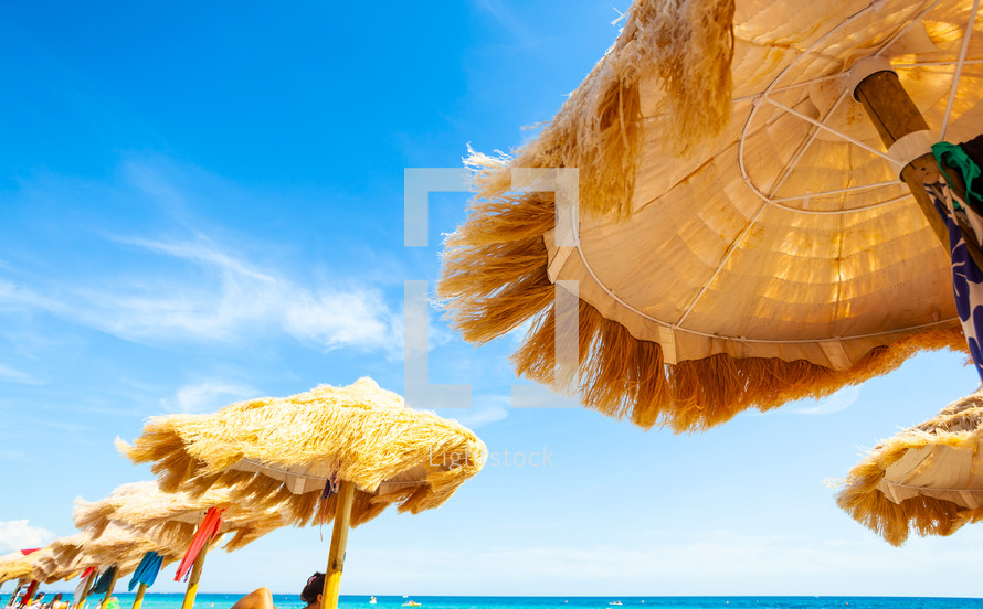 thatched umbrellas and bright turquoise sea, great recreation and relaxation.