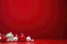 Christmas background with red and silver balls on a red background with copy space