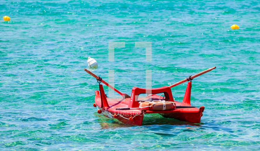 View of an italian lifeguard boat (salvataggio) in beautiful clear tropical sea water from Gallipoli, Italy.