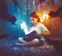 A young child reads a Bible with glowing lights and darkness fighting in a battle