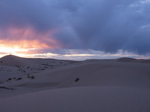 Sand dunes in the desert at sunset