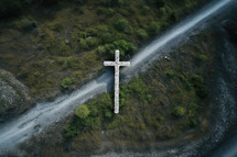 Aerial view of a cross in the middle of a mountain road