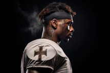 Team Jesus. African-american football player on black background with copy space