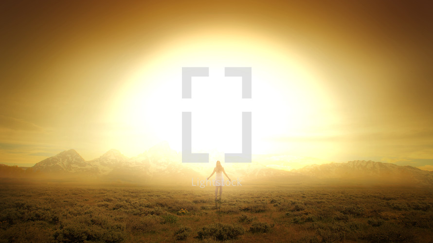 a woman standing in front of a radiating sunrise 