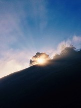 sunlight behind a mountain 