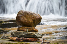 stacked rocks and a waterfall