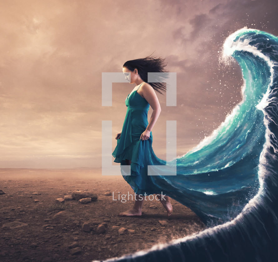 A woman with a blue dress and large wave behind her