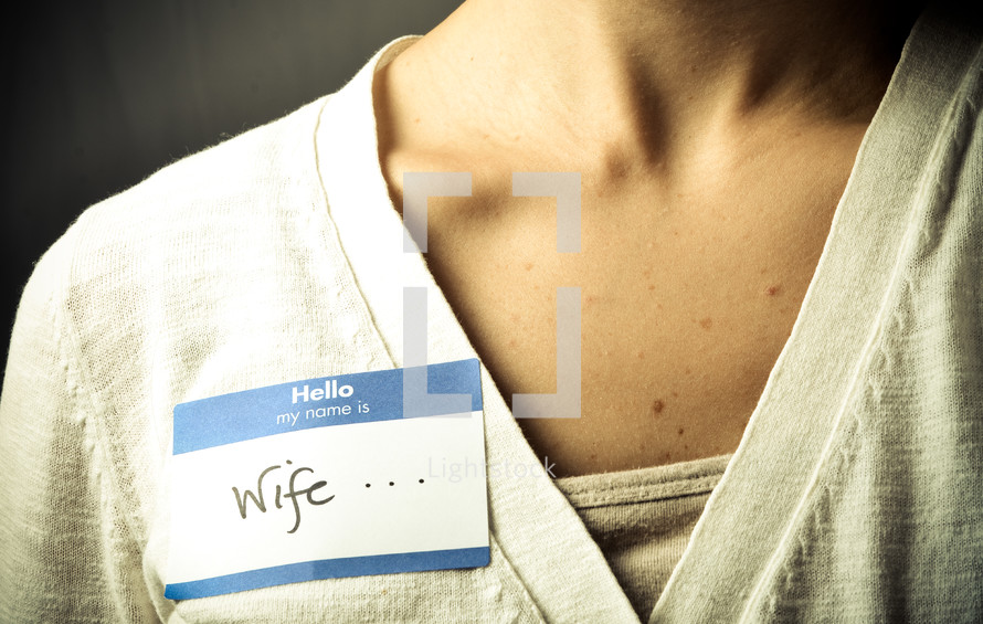 woman wearing a name tag with the word wife