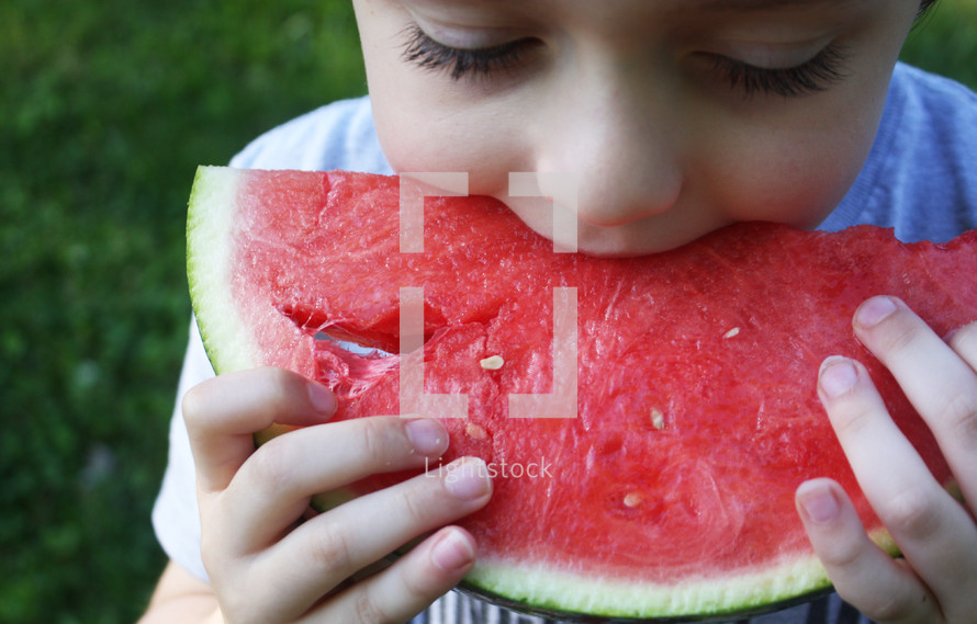 a child eating a watermelon 