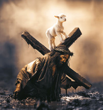 Small lamb on top of the cross of Jesus