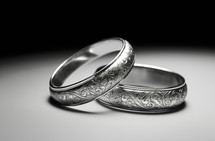Close-up macro shot of two rings placed on a table