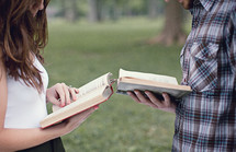 man and a woman reading the Bible to each other 
