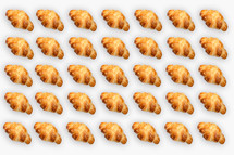 Pattern from croissants isolated on gray background. Bakery pattern with baked croissant.
