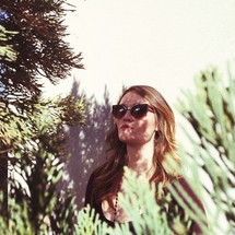 A woman wearing sunglasses outdoors 