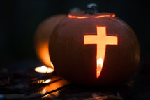 pumpkin carved with cross - candle light