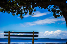 empty park bench with ocean view 