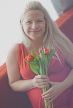 a pregnant woman holding tulips