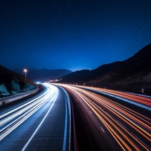 In a long exposure night shot of a highway, blurred lights streak across the frame, producing a dynamic and energetic ambiance