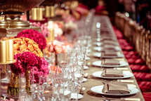 a banquet table with place settings and centerpieces 