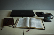 laptop computer, open BIBle, journal, pen, coffee mug on a desk 