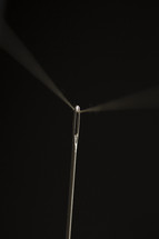close up of a needle and thread.