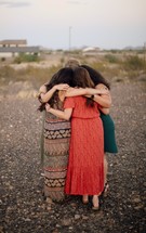 women's group standing together in prayer 