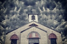 boarded up church under a cloudy sky