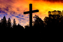 Cross silhouette against a colorful sky at sunset 