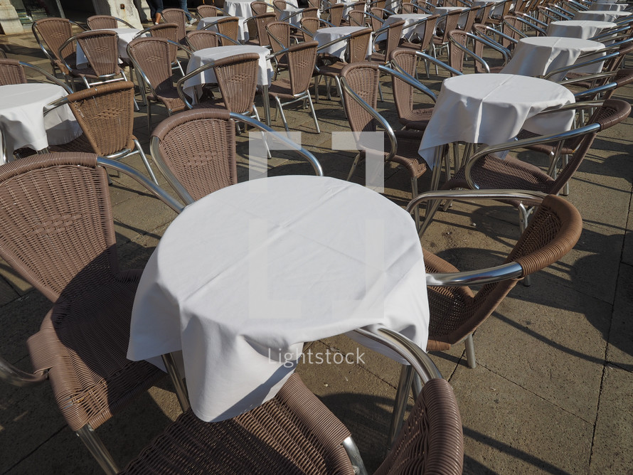 Many tables and chairs at an outdoor alfresco bar
