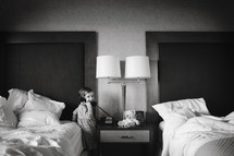 girl child on the phone in a hotel room 