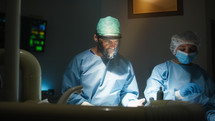 Doctor and assistant works in operating room