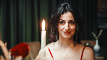 Woman smiling at candle light dinner