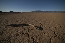 A barren desert landscape with distant mountains